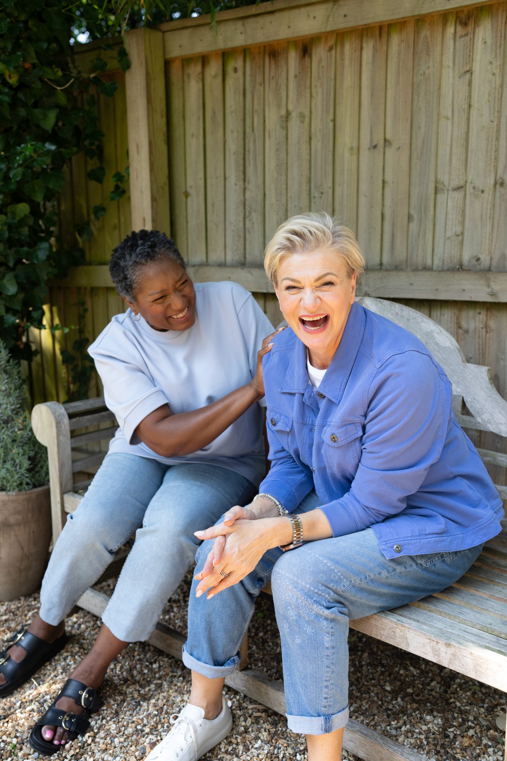 2 women on a bench laughing