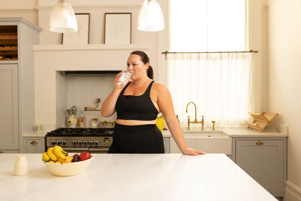 Woman drinking in the kitchen