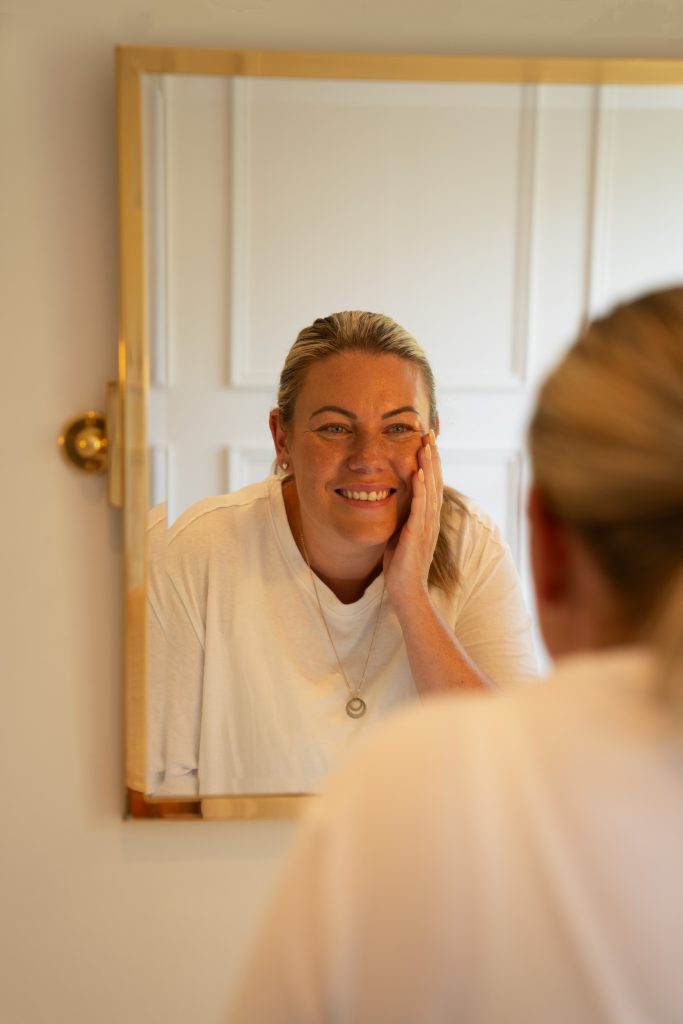 Woman looking at self in mirror