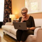 Woman on sofa on laptop