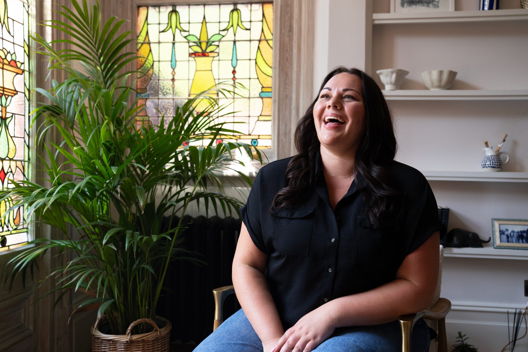 woman sat in chair laughing