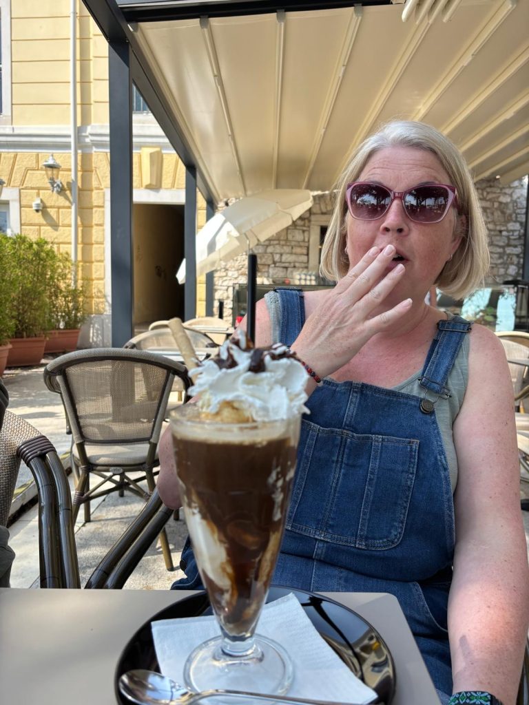 Women with shocked happy reaction in front of chocolate sundae