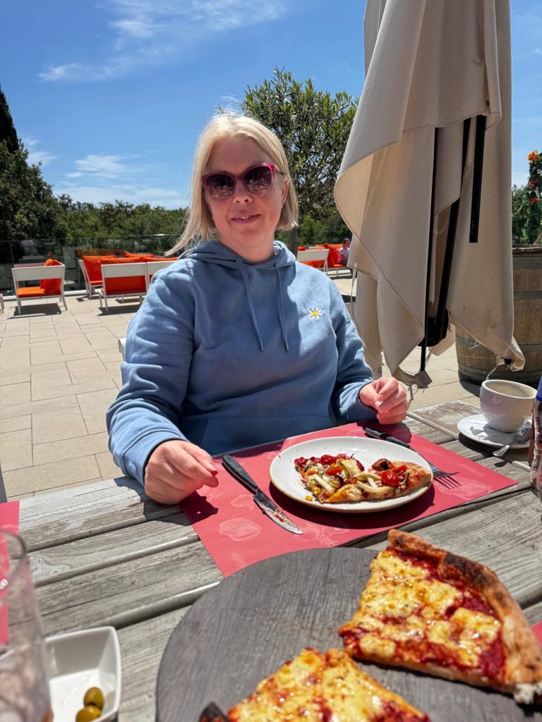 Women outside with plate of food in front of her