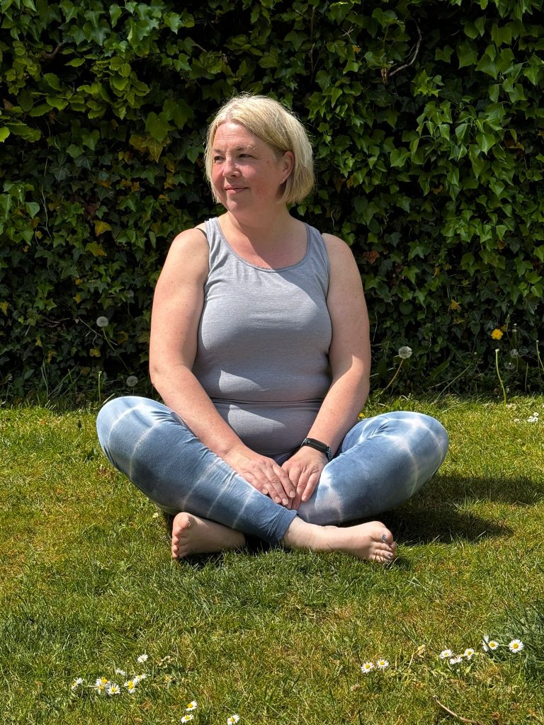 Women sat in field in gym attire