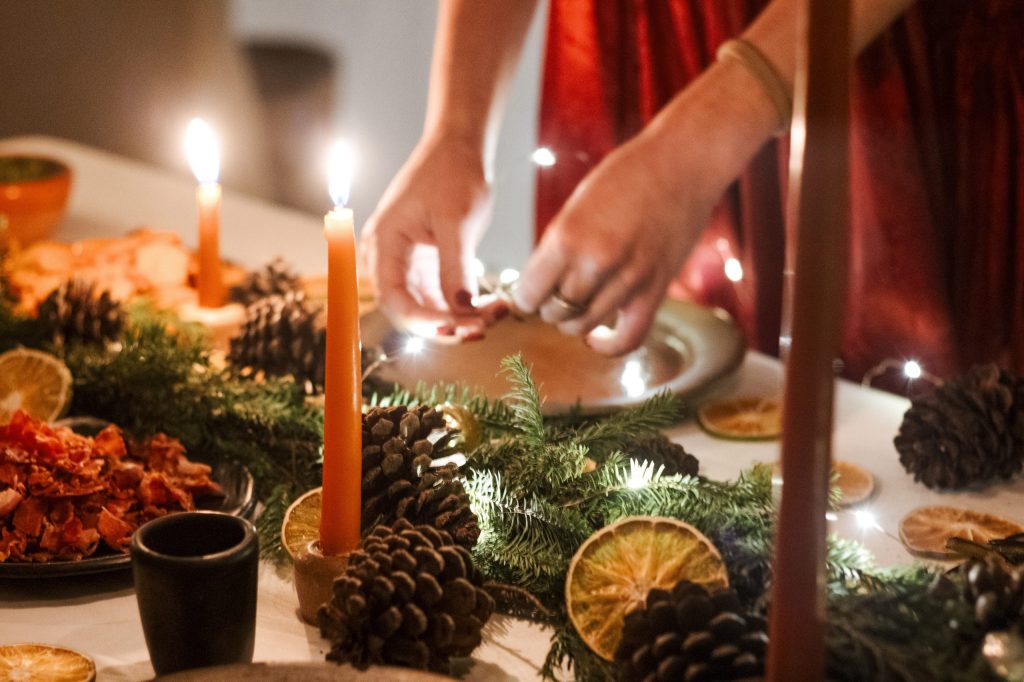 woman decorates a Christmas plate
